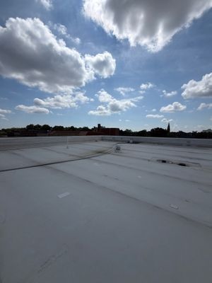 The healthcare facility's low-slope TPO roof, perimeter walls and rooftop components.