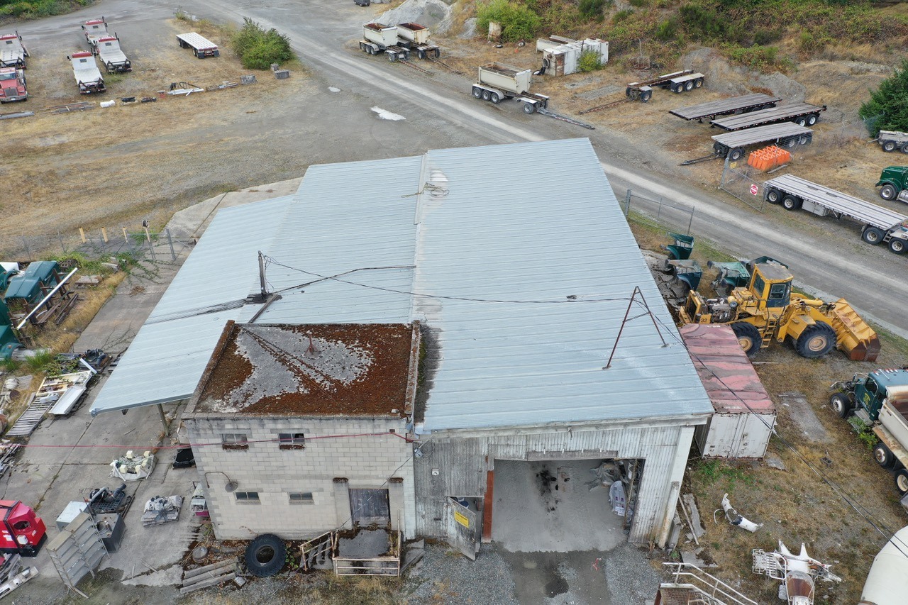 The industrial warehouse's main corrugated-metal roof and smaller elevated roof section.