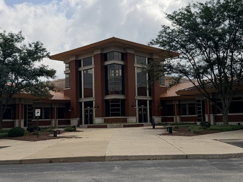Front elevation of the Louisville-area office building beneath its standing-seam metal roof.