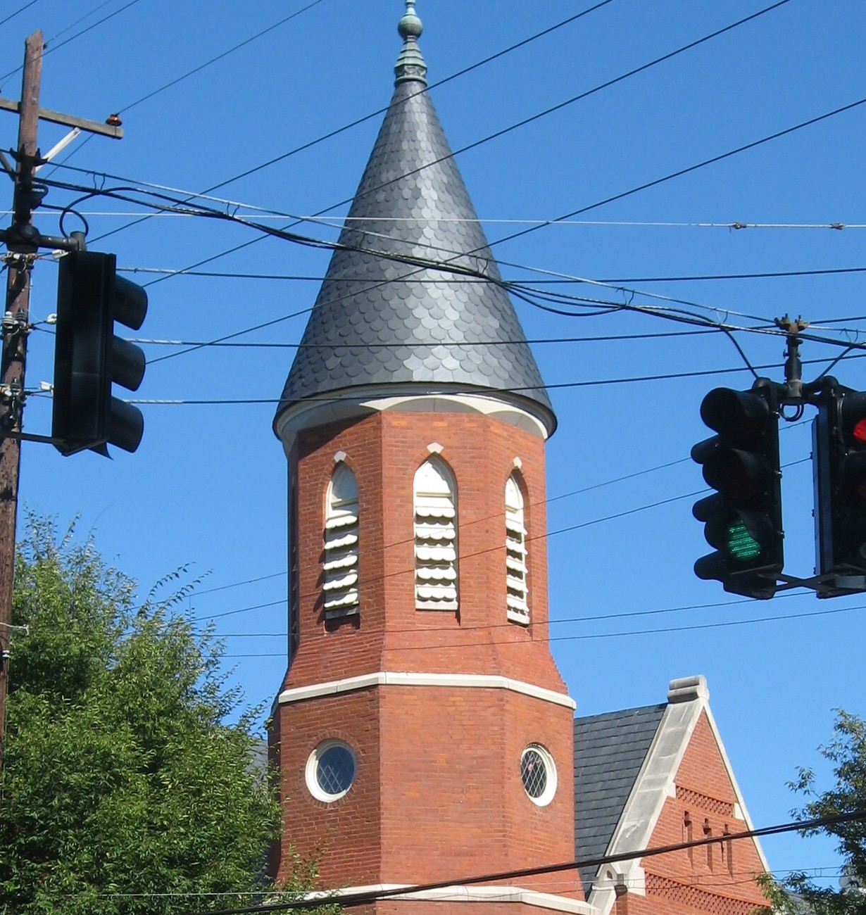 Historic Louisville church exterior with slate-covered tower and brick masonry.